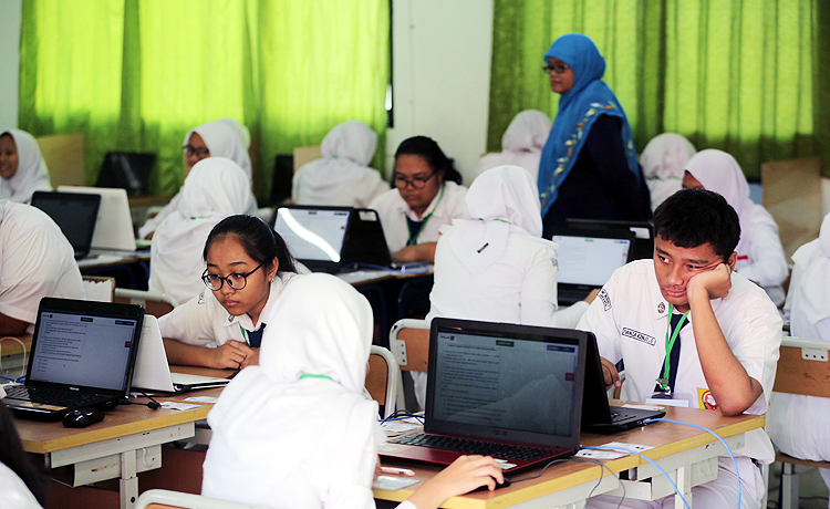 Siswa siswi SMP 1, Jalan Cikini, Jakarta serius mengerjakan soal ujian Nasional Berbasis Komputer. Robinsar Nainggolan