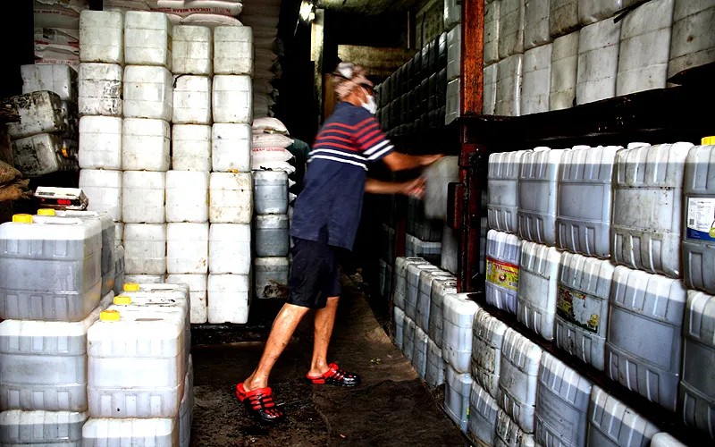 Pekerja saat mengisi minyak curah ke dalam jeriken di Pasar Kebayoran Lama, Jakarta, Rabu (25/5). Direktur Jenderal Industri Agro Kementerian Perindustrian (Kemenperin) Putu Juli Ardika mengatakan pemerintah akan mencabut subsidi minyak goreng curah per 31 Mei mendatang. Alasan dihentikannya program subsidi minyak goreng curah ini lantaran harga komoditas tersebut sudah turun dibandingkan harga beberapa bulan yang lalu. Saat ini harga minyak curah dibanderol Rp16.000 per kilogram. Robinsar Naing